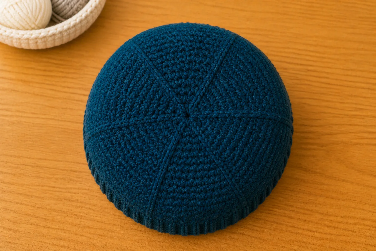 An overhead view shows six balanced decrease lines meeting at the center of a finished deep-teal hat crown